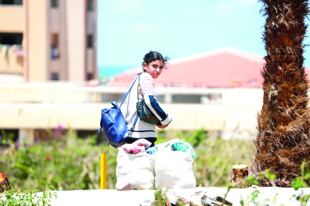 A displaced Palestinian leaves with their belongings from Rafah following an evacuation order by the Israeli army on Monday. — AFP