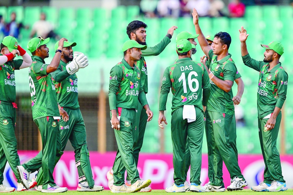 Bangladesh's Mohammad Saifuddin (2R) celebrates with teammates after taking the wicket of Faraz Akram Joylord Gumbie (not pictured) during the third Twenty20 international cricket match between Bangladesh and Zimbabwe at the Zahur Ahmed Chowdhury Stadium in Chittagong on May 7, 2024. 