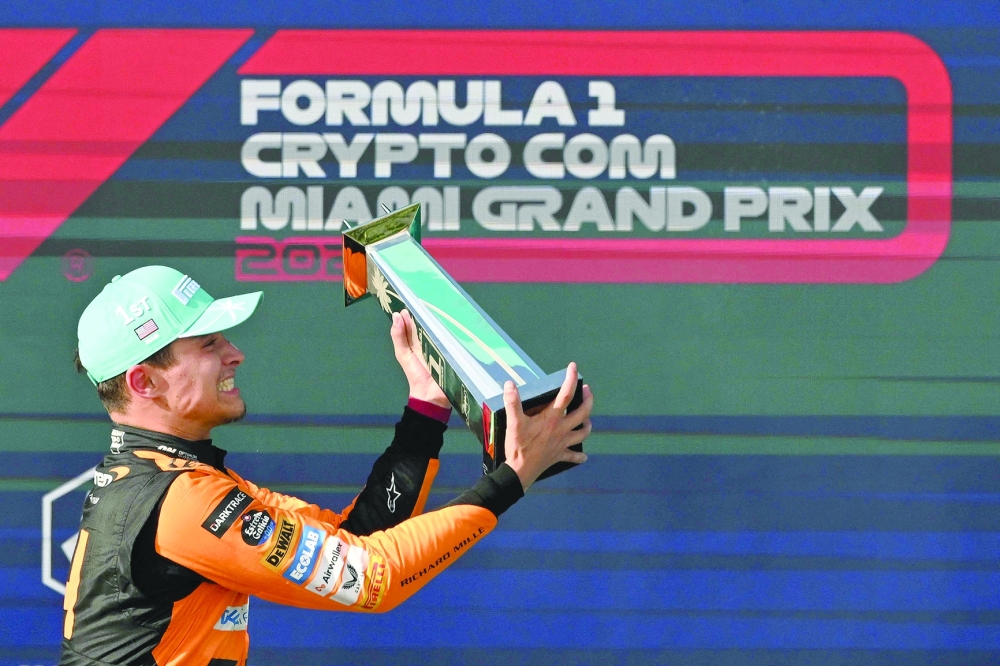 McLaren's British driver Lando Norris celebrates with his trophy on the podium after winning the 2024 Miami Formula One Grand Prix at Miami International Autodrome in Miami Gardens, Florida, on May 5, 2024.  