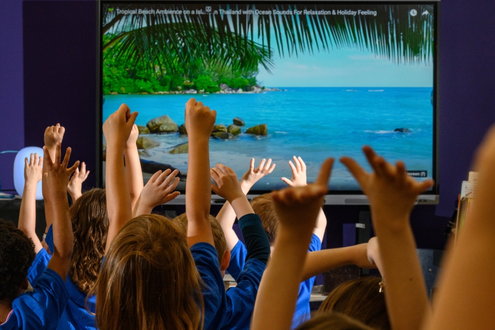 Students practice yoga during a mental health fair at Woodsdale Elementary School in Wheeling, W.Va., April 19, 2024. (Rebecca Kiger/The New York Times)