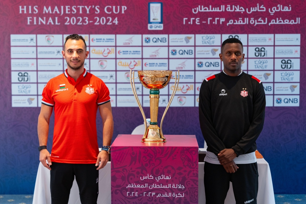 Dhofar assistant coach Mohammed al Sayyed and Qasim Said pose with the HM Cup.
