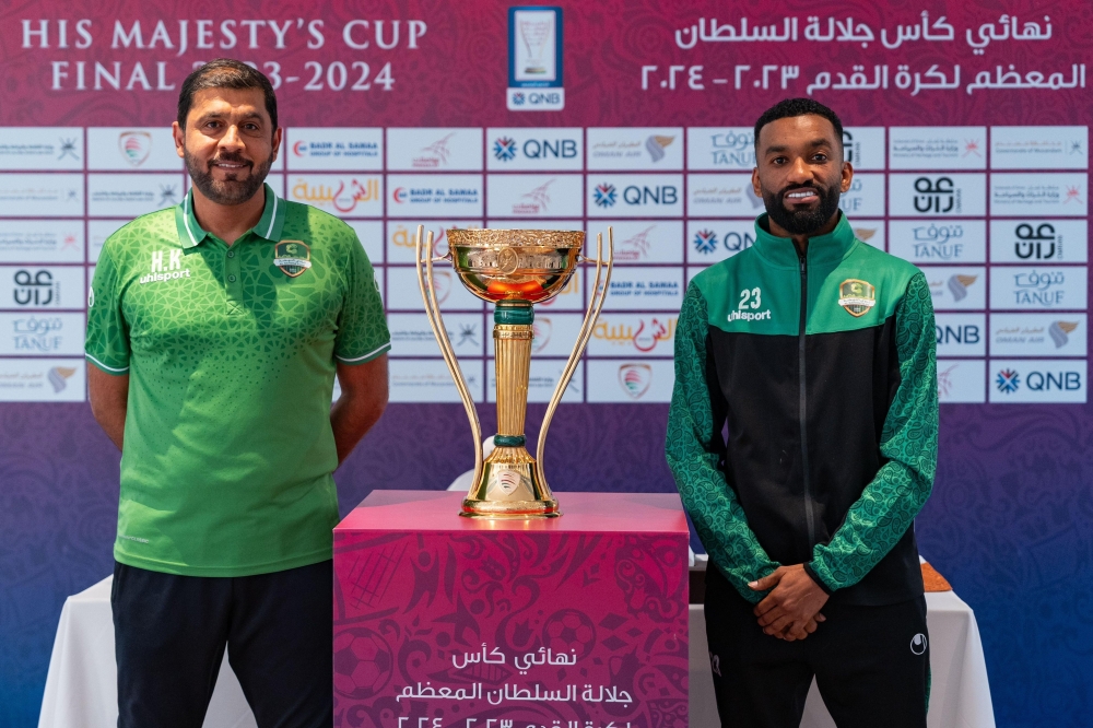 Al Nahda head coach Hamad al Azzani and captain Harib al Saadi pose with the trophy.