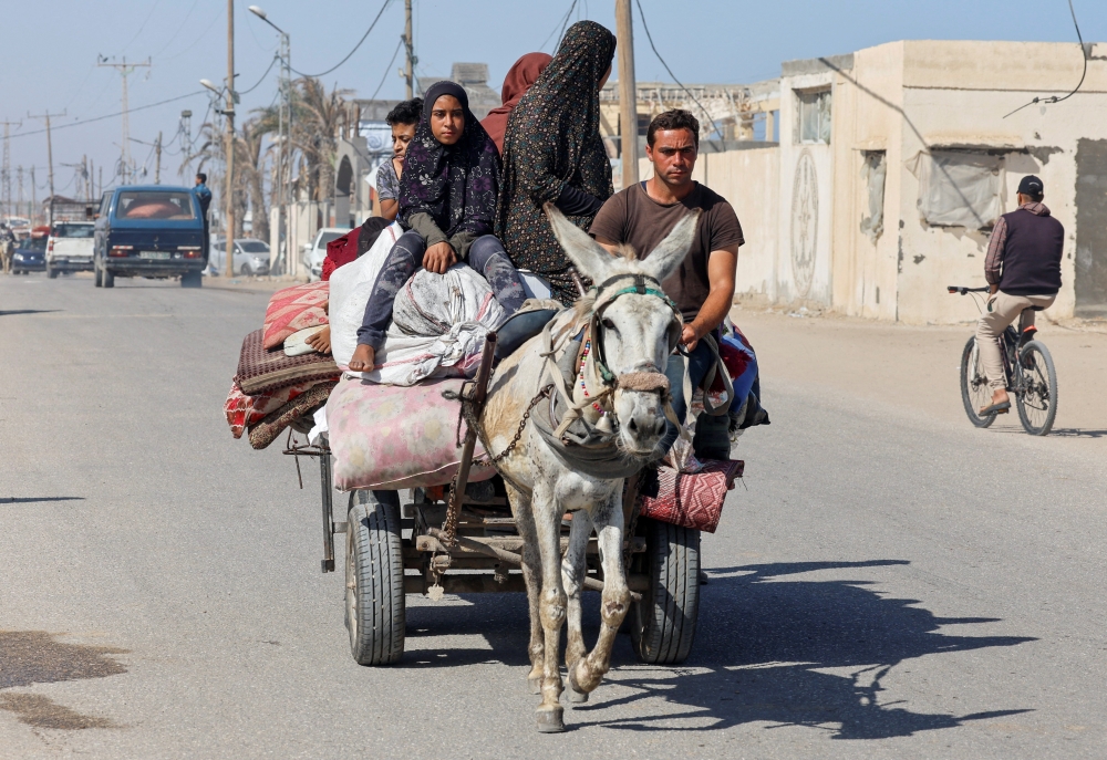Palestinians flee Rafah after Israeli forces launched a ground and air operation in the eastern part of the city on Thursday. — Reuters