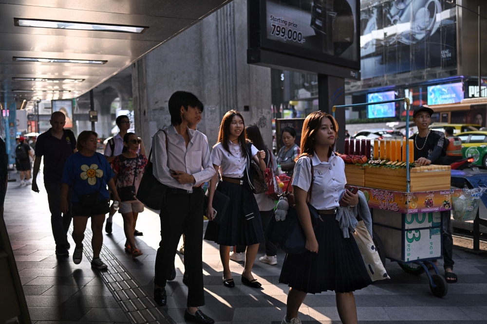 University students walk around Siam Square in Bangkok on May 8, 2024.