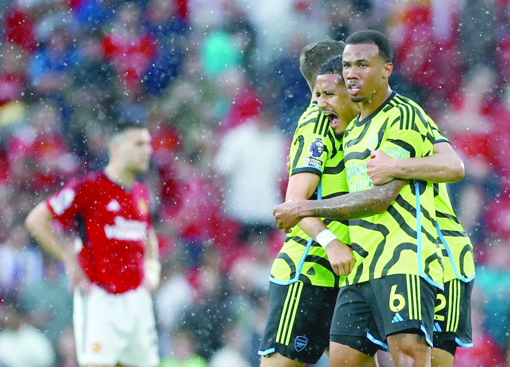Manchester United v Arsenal's William Saliba and Gabriel celebrate after the match.— REUTERS