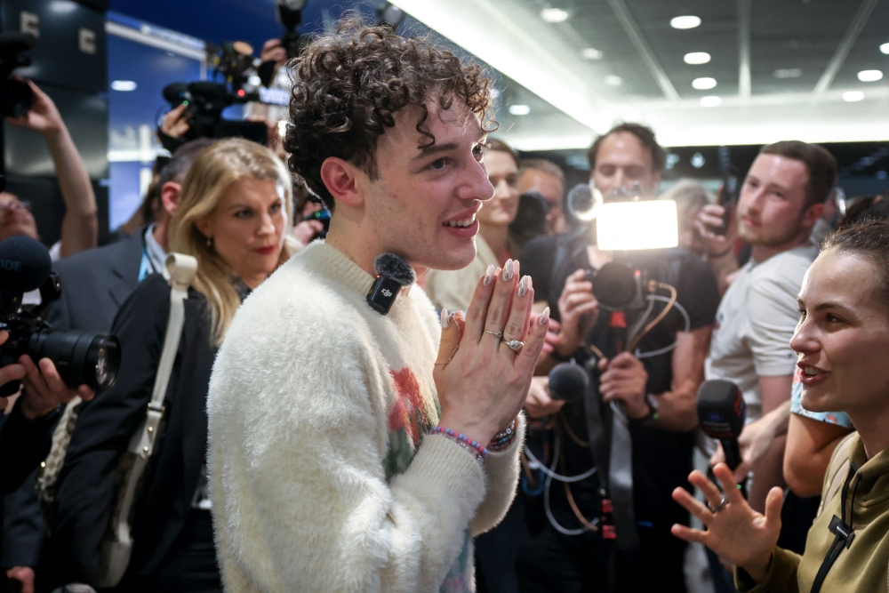 Swiss singer Nemo who won the final of the 68th Eurovision Song Contest (ESC) 2024 with the song "The Code" is welcomed by supporters and press after landing at Zurich Airport on late May 12, 2024. Switzerland promised a joyous celebration for Nemo Mettler, the first non-binary performer to win the Eurovision Song Contest at the end of one of the most politically-charged competitions ever. (Photo by ARND WIEGMANN / AFP)


