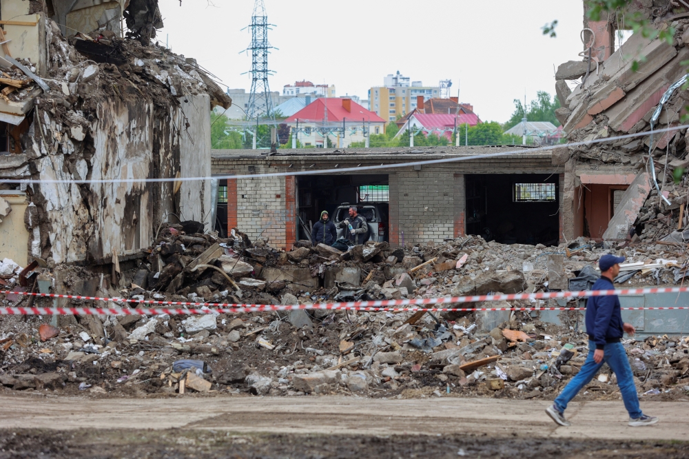 Workers remove debris of a damaged multi-story apartment block, in the city of Belgorod. — Reuters 
