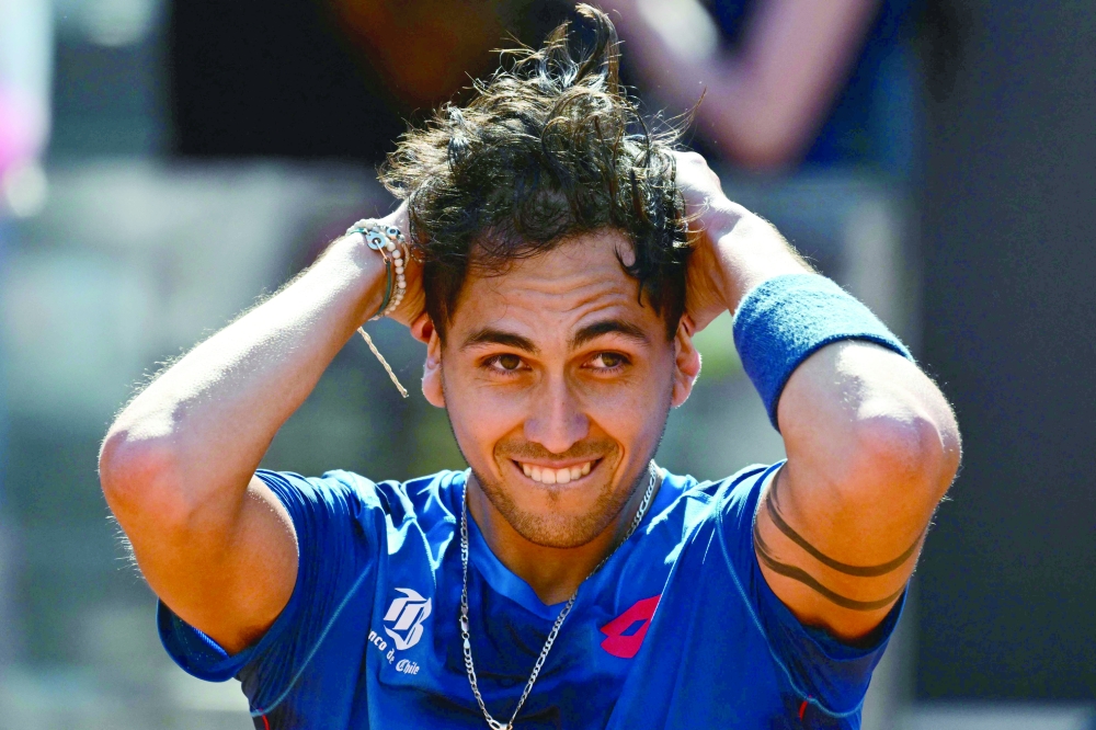 Chile's Alejandro Tabilo celebrates after winning his match against Serbia's Novak Djokovic at the Men's ATP Rome Open tennis tournament at Foro Italico in Rome on May 12, 2024.  (Photo by Tiziana FABI / AFP)
