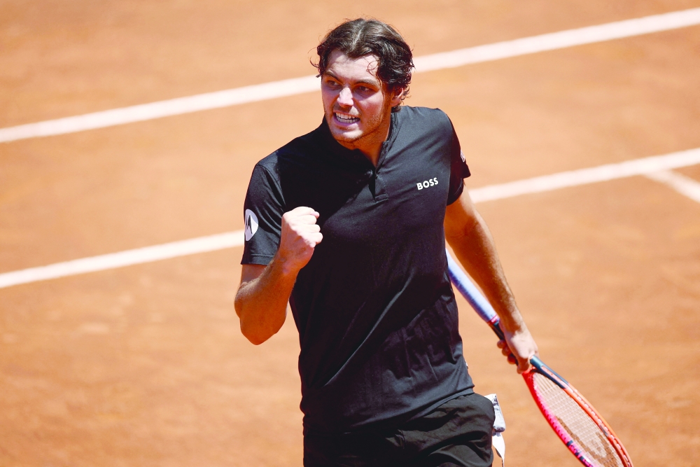 Taylor Fritz of the U.S. celebrates after winning his round of 16 match against Bulgaria's Grigor Dimitrov. Italian Open - Foro Italico, Rome, Italy - May 14, 2024. - REUTERS/Guglielmo Mangiapane