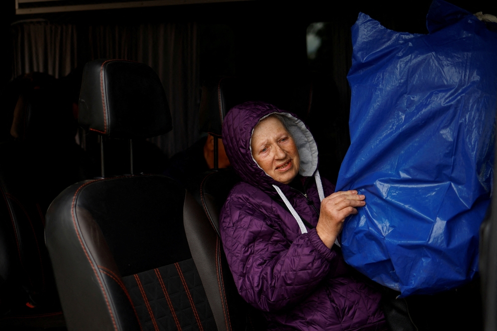Vovchansk resident holds a covered cage with a parrot as she sits inside an evacuation bus to Kharkiv, amid Russia's attack on Ukraine, near the frontline town of Vovchansk, in Kharkiv region, Ukraine, on Tuesday. - Reuters