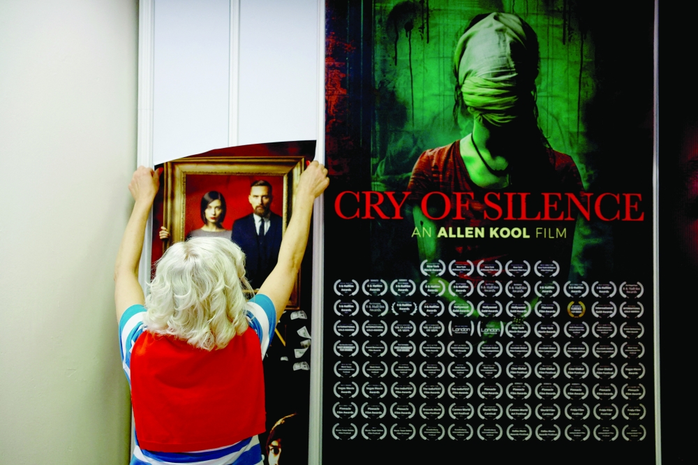 A woman sets up a stand inside the Film Market business area before the start of the 77th Cannes Film Festival in Cannes, France, May 13, 2024. REUTERS/Sarah Meyssonnier/File Photo