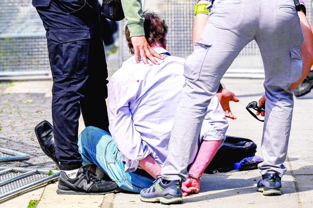 A person is detained after a shooting incident of Slovak PM Robert Fico, after a Slovak government meeting in Handlova on Wednesday. — Reuters