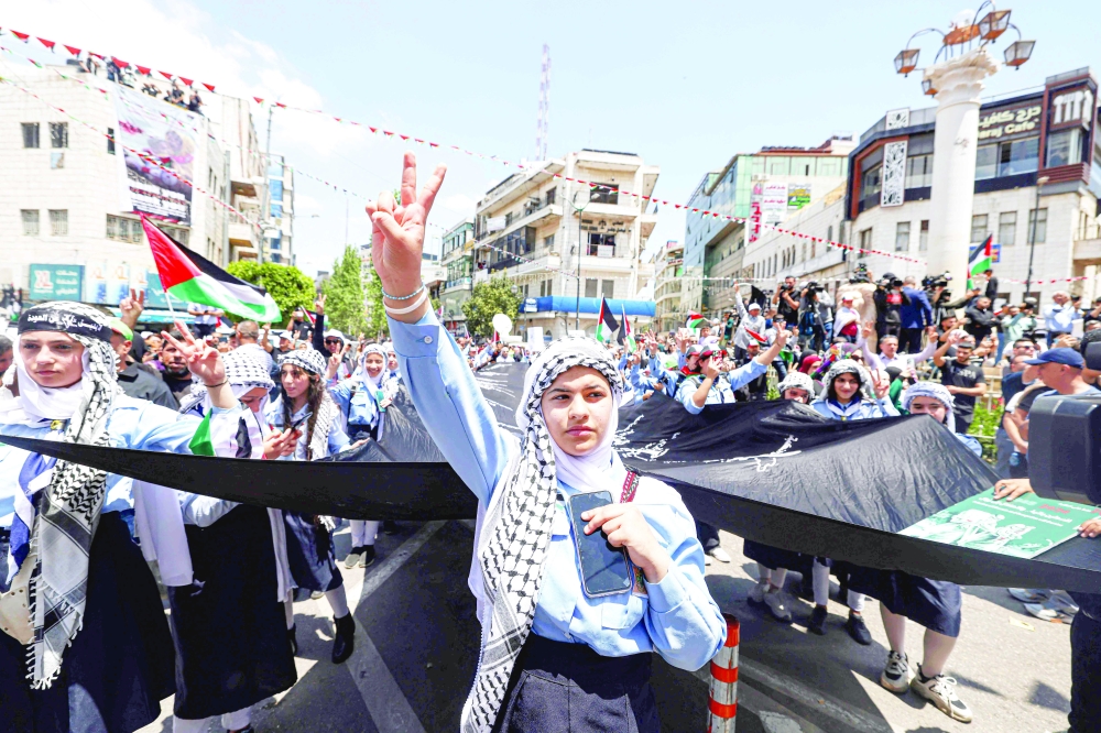 Palestinian protesters take to the streets of the West Bank city of Ramallah on Wednesday to mark the 76th anniversary of the "Nakba" or "Catastrophe" of the creation of Israel, which sparked the exodus of hundreds of thousands of Palestinians in 1948. — AFP 

