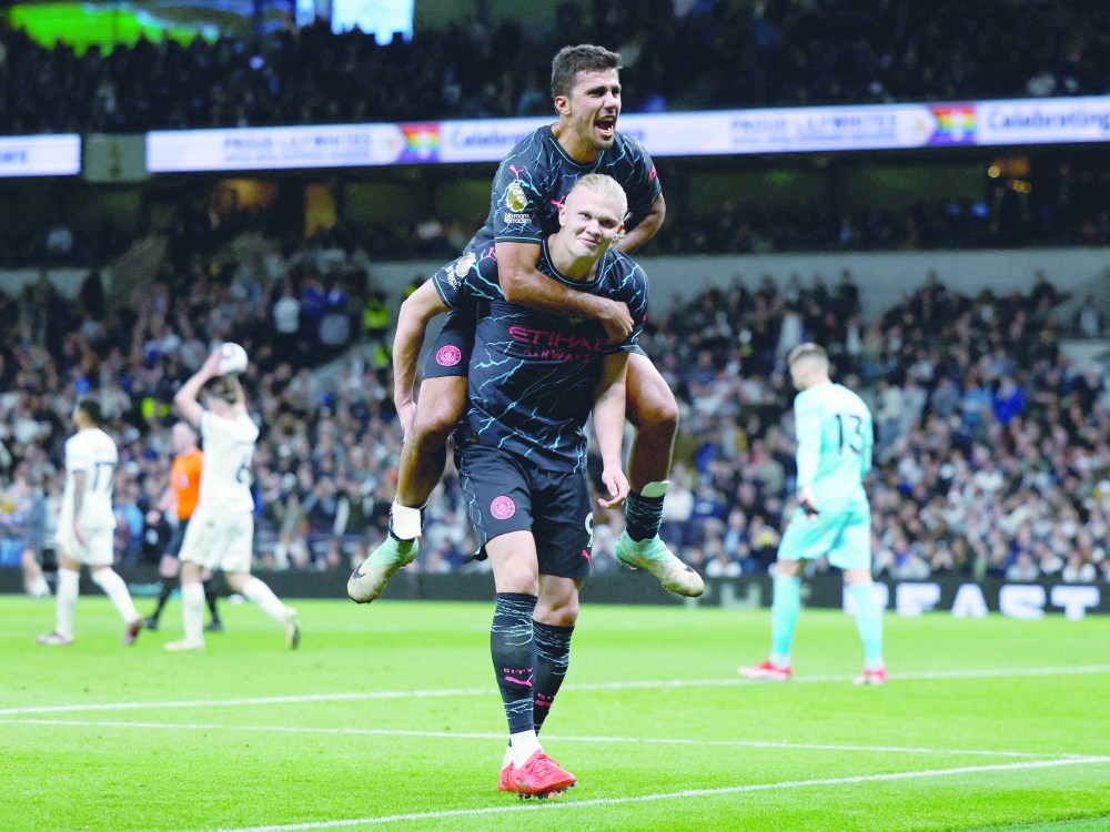 Erling Braut Haaland celebrates scoring their second goal with Rodri Action Images via Reuters