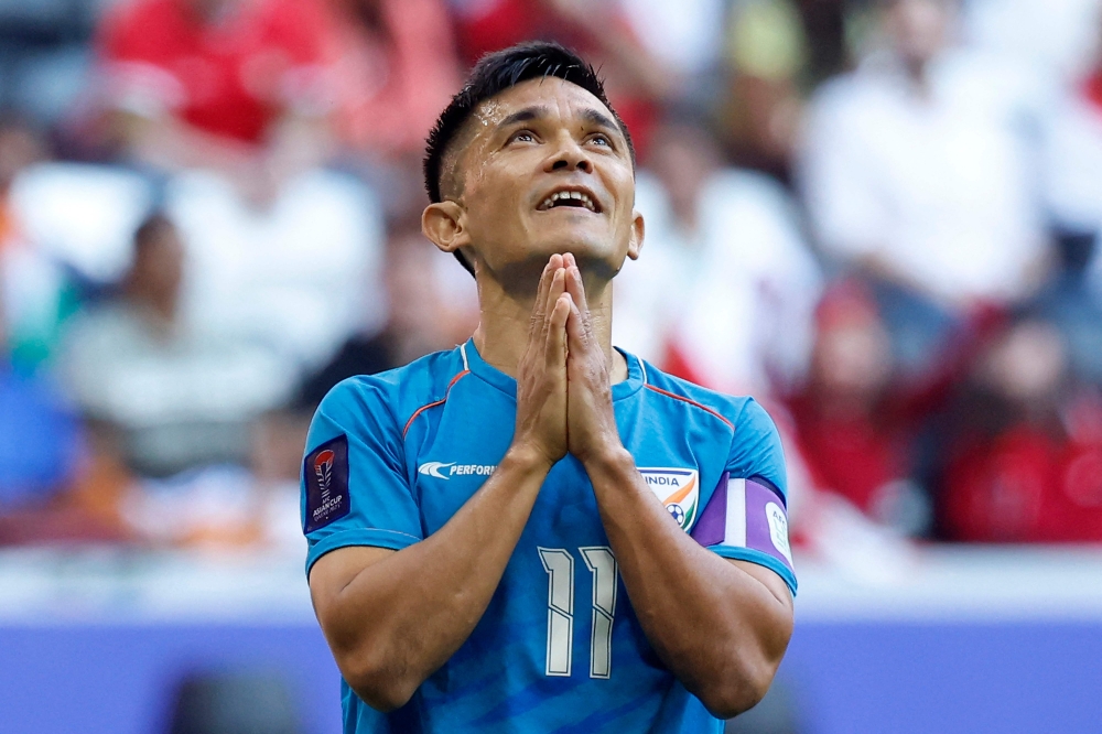 (FILES) India's forward #11 Sunil Chhetri reacts during the Qatar 2023 AFC Asian Cup Group B football match between Syria and India at Al-Bayt Stadium in al-Khor, north of Doha, on January 23, 2024. India's veteran football captain Sunil Chhetri announced his retirement from international competition on May 16, bringing the curtains down on a record career spanning two decades. (Photo by KARIM JAAFAR / AFP)

