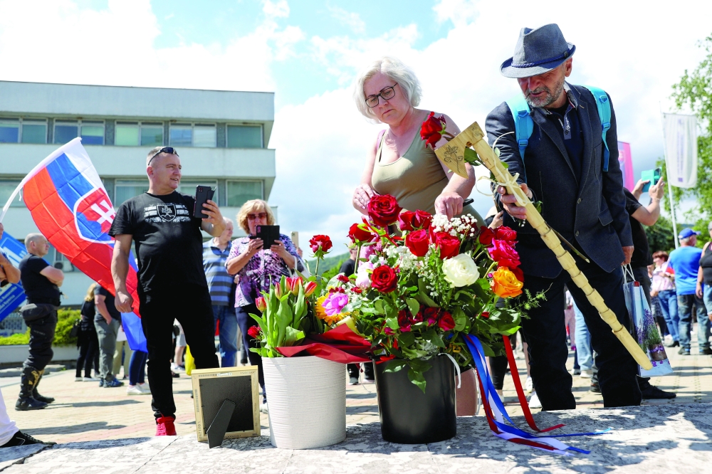Supporters bring flowers and gifts as they gather near the F.D. Roosevelt University Hospital, in Banska Bystrica, Slovakia. — Reuters 
