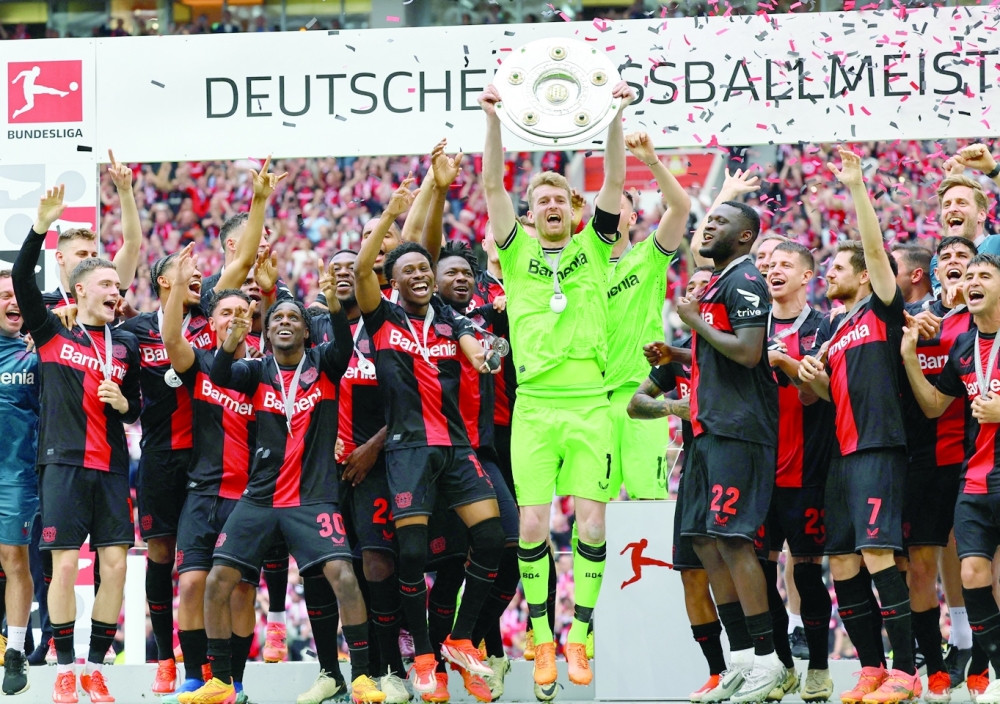  Lukas Hradecky lifts the trophy after winning the Bundesliga and going unbeaten.— REUTERS