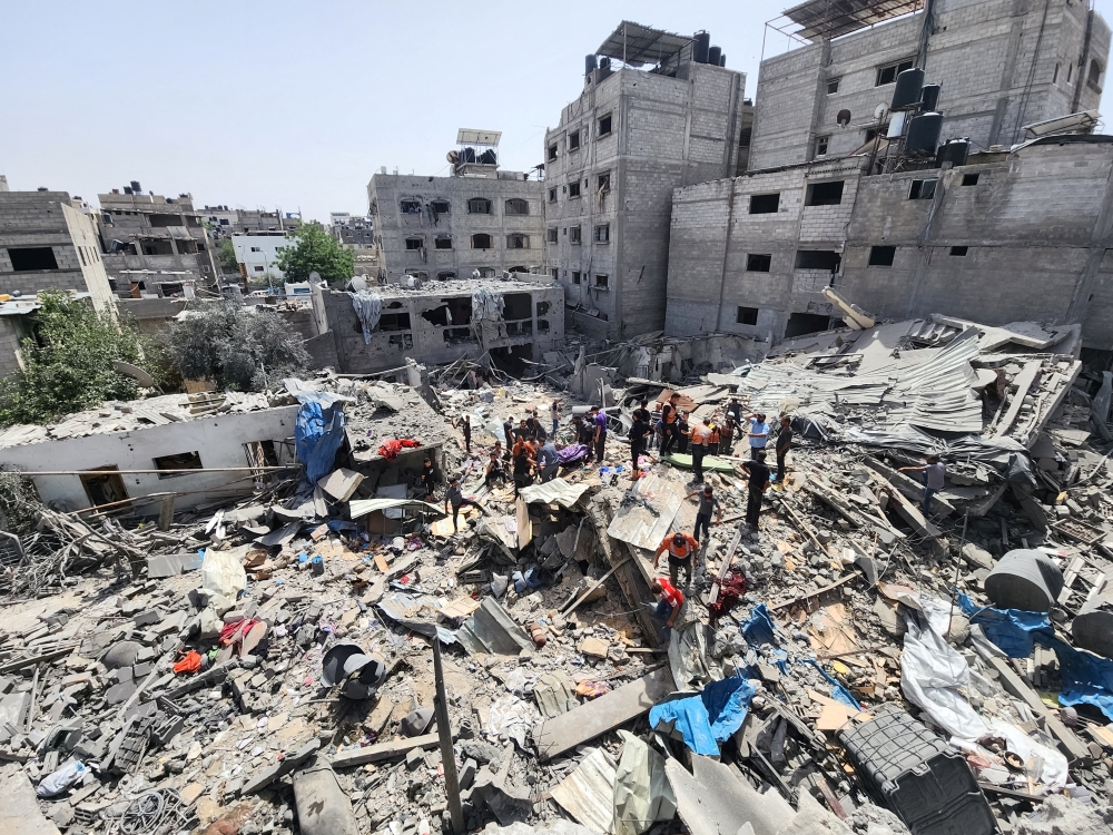 Palestinians carry the body of a person killed in an Israeli strike on a house in Jabalia refugee camp in the northern Gaza Strip on Saturday. — Reuters
