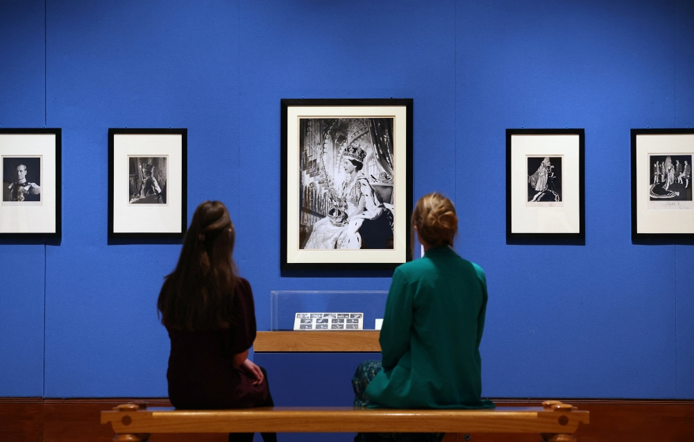 Employees from Royal Collection Trust, Catriona and Meredith pose as they view ‘Coronation Portrait of Queen Elizabeth II’ by Cecil Beaton in 1953 which forms part of the new exhibition ‘Royal Portraits: A Century of Photography’ at The King’s Gallery, Buckingham Palace, in London, Britain, May 16, 2024. REUTERS/Toby Melville ATTENTION EDITORS - NO NEW USES AFTER OCTOBER 6, 2024. IMAGES SHALL BE SOLELY USED FOR NEWS EDITORIAL PURPOSES ONLY IN CONNECTION WITH THE EXHIBITION ROYAL PORTRAITS: A CENTURY OF PHOTOGRAPHY AT THE KING’S GALLERY, BUCKINGHAM PALACE.
