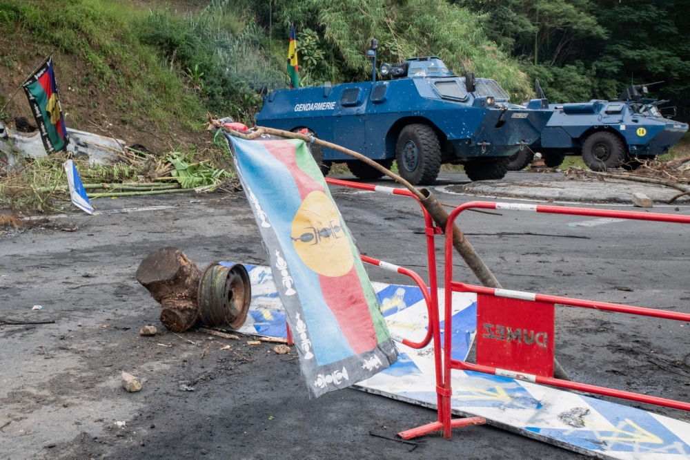 French armored vehicles appear clearing the roadway, parked at La Pirogue, France's Pacific territory of New Caledonia. — AFP 