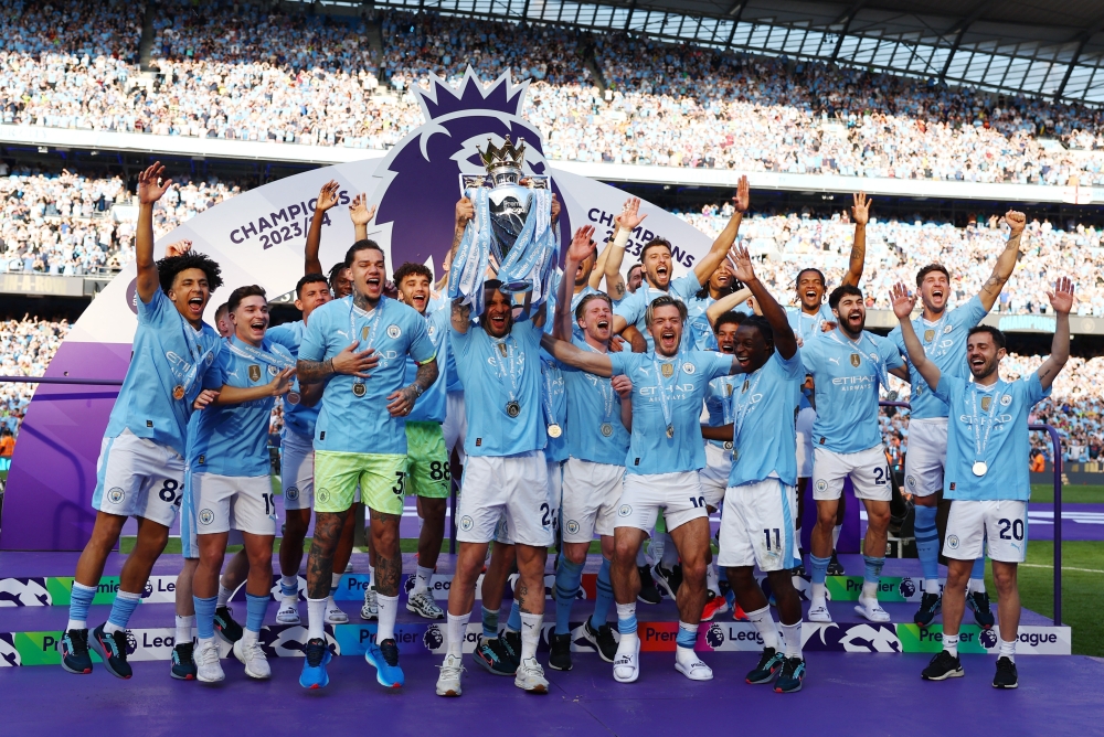  Kyle Walker and teammates celebrate with the trophy.— REUTERS