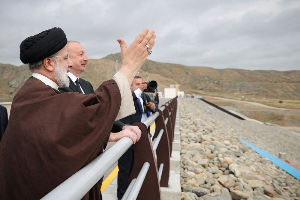 Iranian President Ebrahim Raisi and Azerbaijan's President Ilham Aliyev visit the Qiz-Qalasi dam on the Azerbaijan-Iran border, on May 19, 2024.