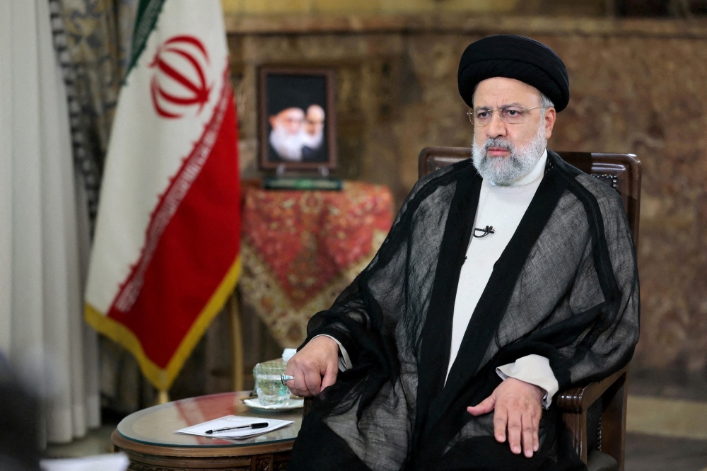 Iranian President Ebrahim Raisi looks on during a TV interview