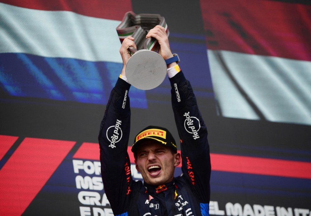 Formula One F1 - Emilia Romagna Grand Prix - Autodromo Enzo e Dino Ferrari, Imola, Italy - May 19, 2024 Red Bull's Max Verstappen celebrates with the trophy on the podium after winning the Emilia Romagna Grand Prix REUTERS/Massimo Pinca
