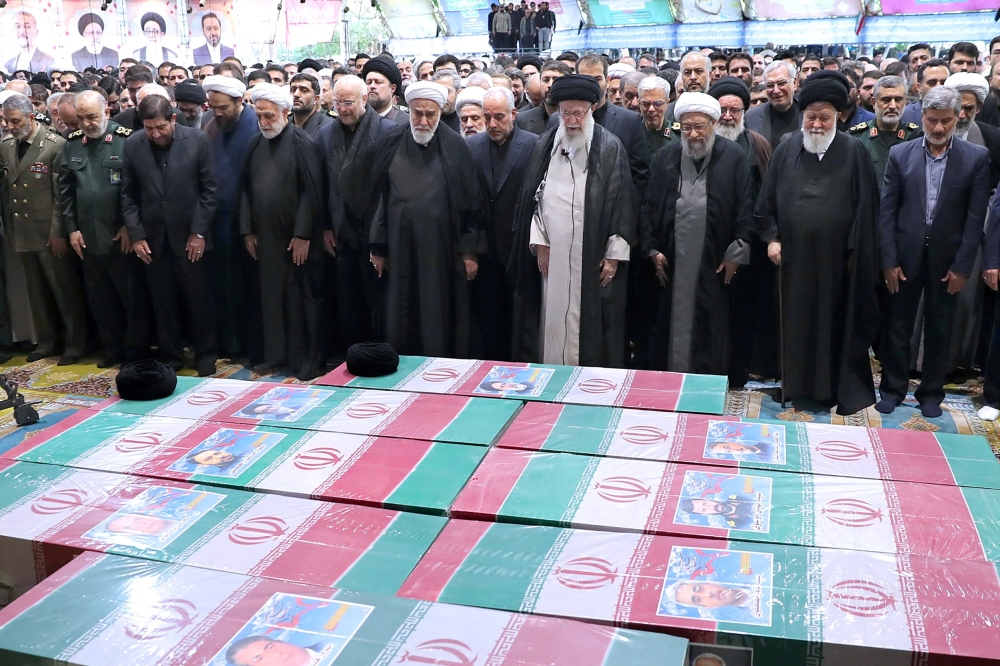 Ayatollah Ali Khamenei performs prayer at a funeral for Ebrahim Raisi in Tehran on Wednesday. — Reuters