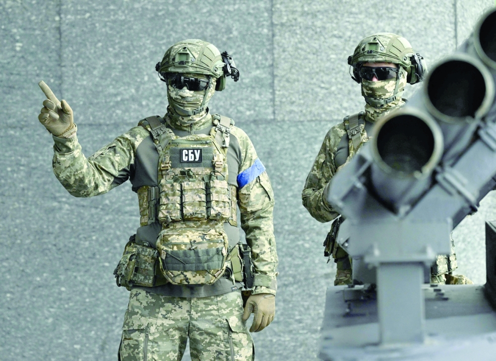 Servicemen of the Security Service of Ukraine stand next to a marine drone "SeaBaby" equipped with multiple launch rocket, in Kyiv. 