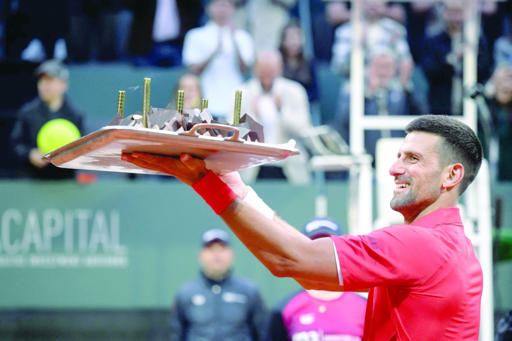 Serbia's Novak Djokovic reacts with his birthday cake after winning his ATP 250 Geneva Open tennis tournament single match against Germany's Yannick Hanfmann 