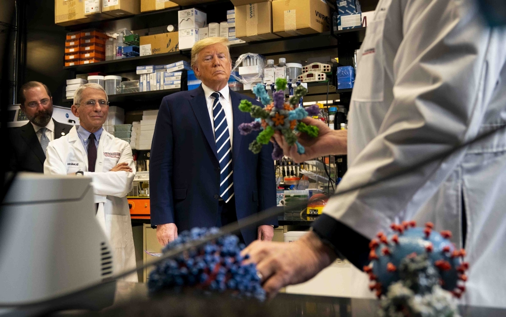 President Donald Trump views models of the coronavirus during a tour at the National Institutes of Health in Bethesda, Md., March 3, 2020. (Doug Mills/The New York Times)