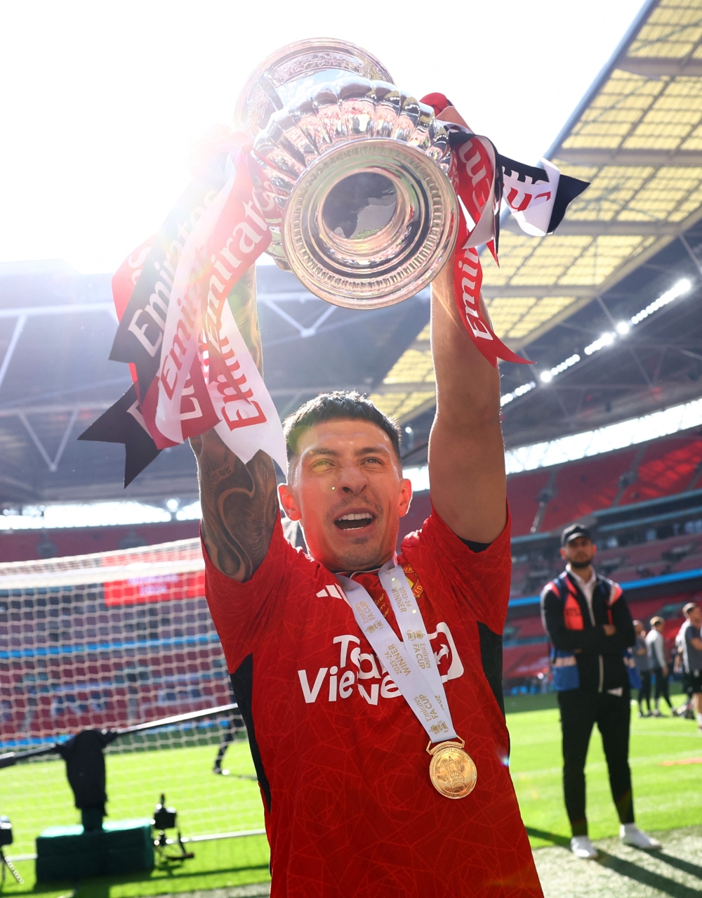  Manchester United's Lisandro Martinez celebrates with the trophy.—REUTERS