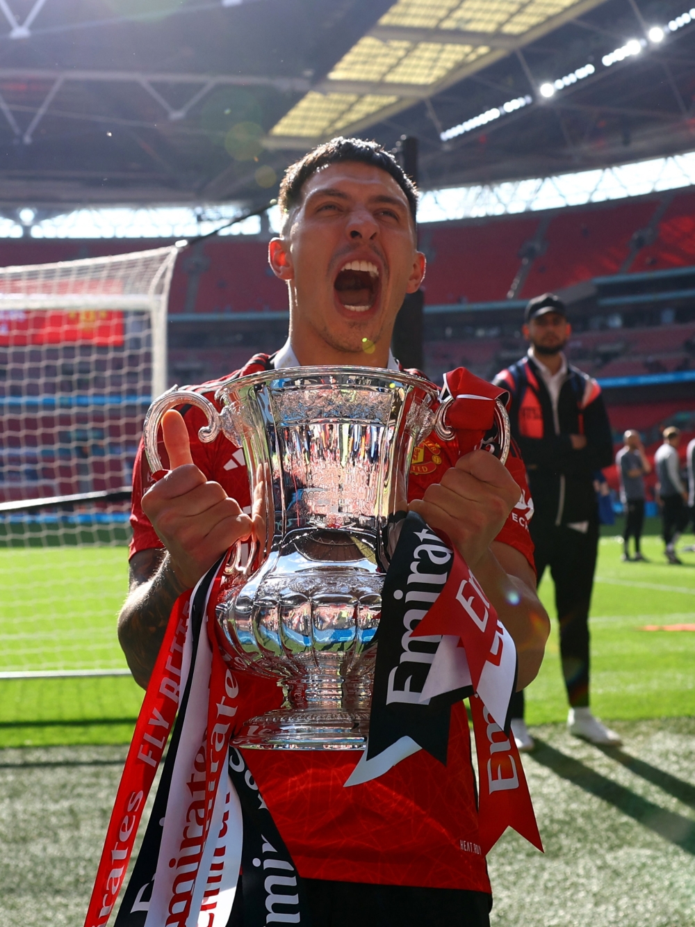 Manchester United's Lisandro Martinez celebrates with the trophy.—REUTERS