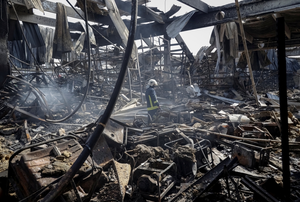 Firefighters work at a site of a household items shopping mall hit by Russian airstrike, in Kharkiv. — Reuters 