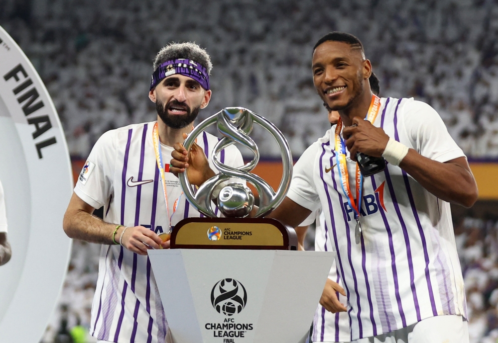 Soccer Football - Asian Champions League - Final - Second Leg - Al Ain v Yokohama F Marinos - Hazza bin Zayed Stadium, Abu Dhabi, United Arab Emirates - May 25, 2024 Al Ain's Yahia Nader and Kodjo Laba celebrate with the trophy after winning the AFC Champions League final REUTERS/Rula Rouhana
