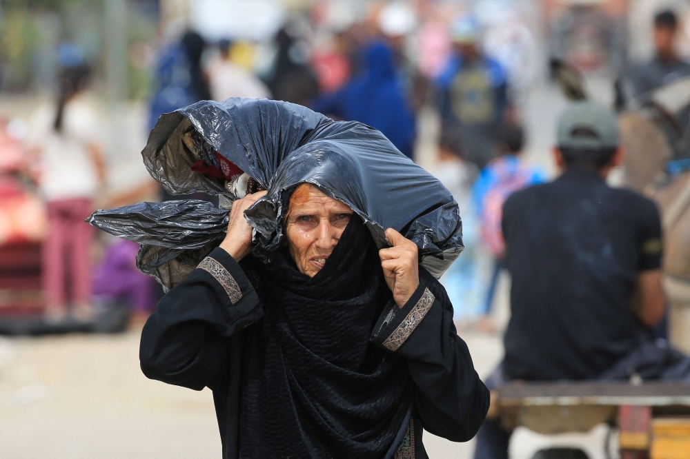 Palestinians flee the area of Tal al Sultan in Rafah with their belongings following renewed Israeli strikes in the city in the southern Gaza Strip on Tuesday. - AFP

