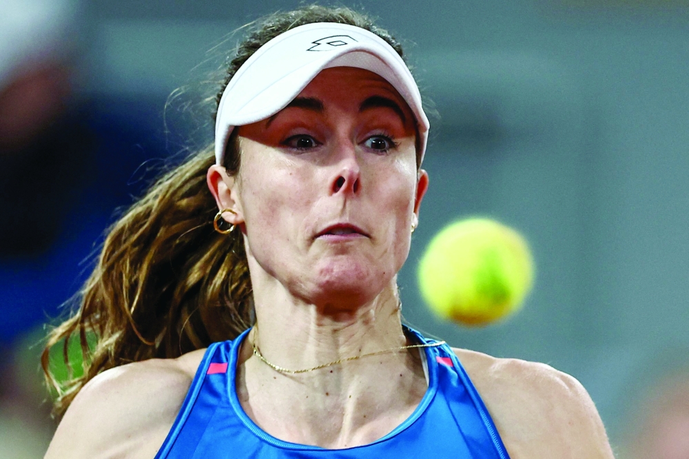 France's Alize Cornet eyes the ball as she plays against China's Zheng Qinwen 