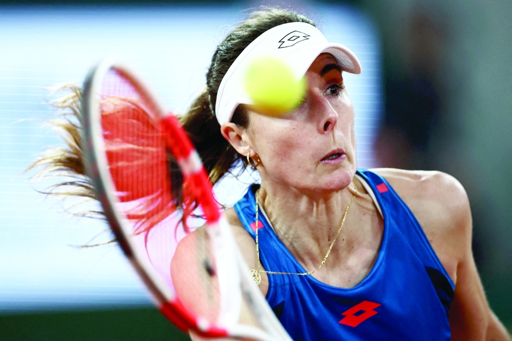 France's Alize Cornet plays a forehand return to China's Zheng Qinwen 