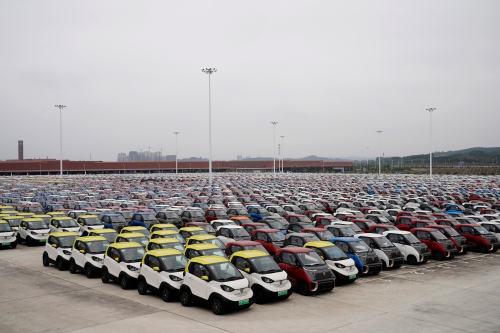 FILE PHOTO: Baojun E100 and E200 all-electric battery cars sit parked at a parking lot operated by General Motors Co and its local joint-venture partners in Liuzho