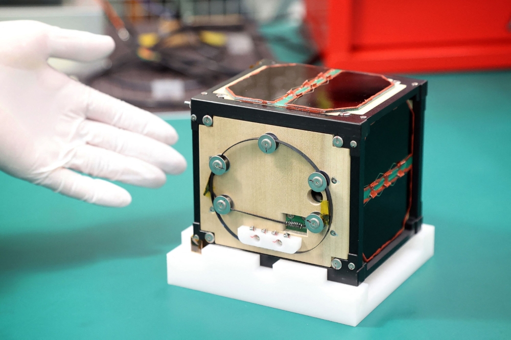 LignoSat is shown during a press conference at Kyoto University in Kyoto on Tuesday. — AFP