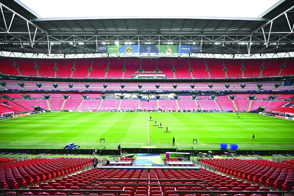 Groundsmen work on the pitch at Wembley Stadium in London on May 31, 2024, as preparations continue on the eve of the UEFA Champions League final football match between Borussia Dortmund and Real Madrid.  