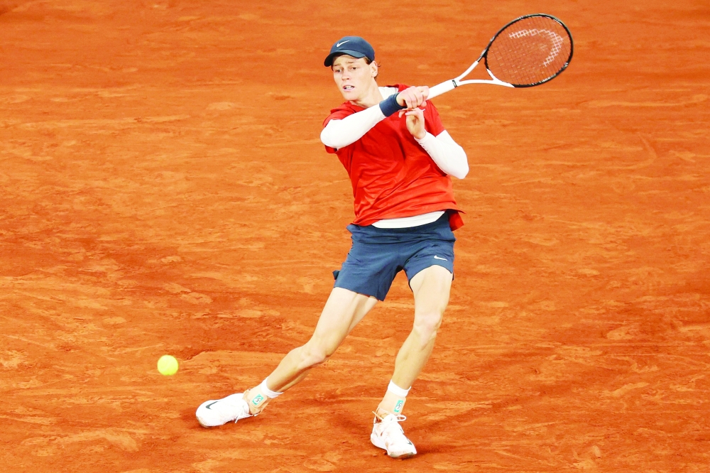 Italy's Jannik Sinner plays a forehand return to Russia's Pavel Kotov during their men's singles match on Court Philippe-Chatrier on day six of the French Open tennis tournament at the Roland Garros Complex in Paris on May 31, 2024.
