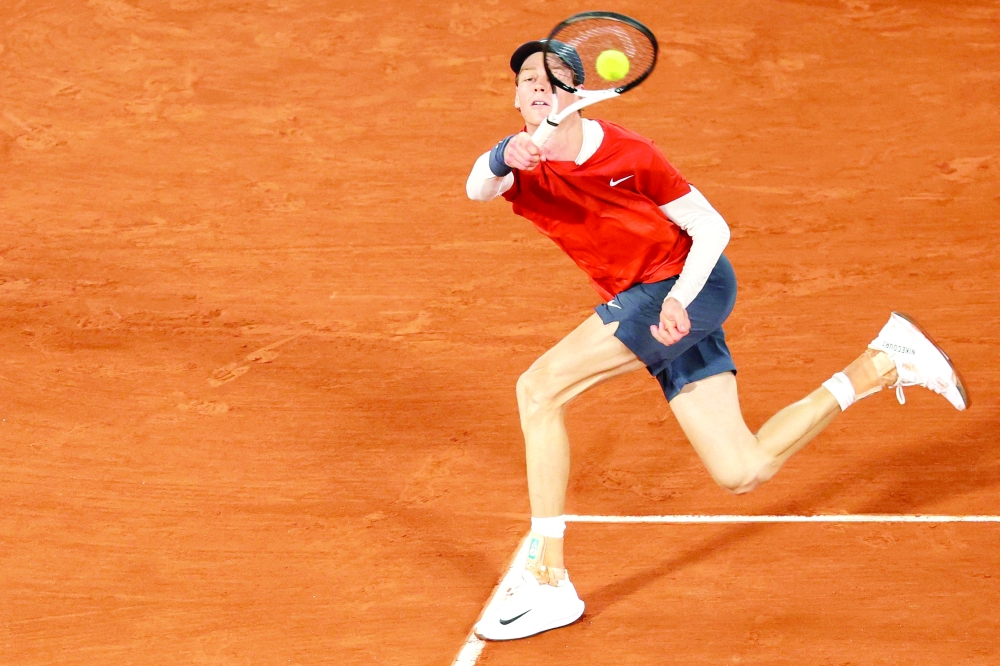 Italy's Jannik Sinner plays a forehand return to Russia's Pavel Kotov during their men's singles match on Court Philippe-Chatrier on day six of the French Open tennis tournament at the Roland Garros Complex in Paris on May 31, 2024.  