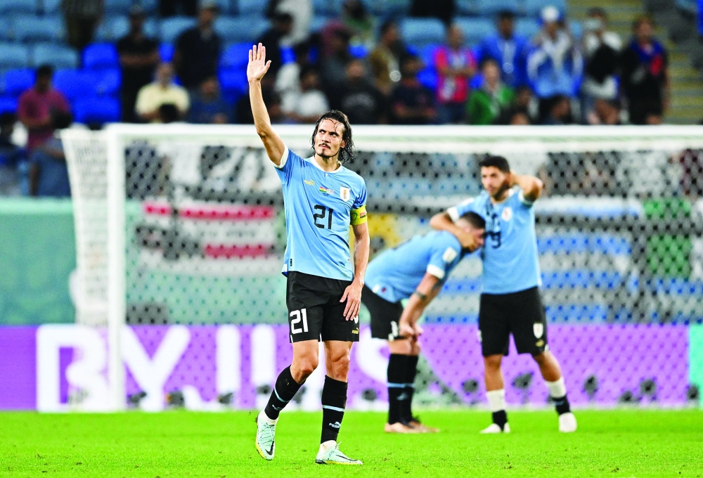 Uruguay's forward #21 Edinson Cavani waves at the end of the Qatar 2022 World Cup Group H football match between Ghana and Uruguay at the Al-Janoub Stadium in Al-Wakrah, south of Doha on December 2, 2022. Cavani announced on May 30 on his social networks that he is resigning from the Uruguayan National team after 16 years, 136 caps and four world cups.