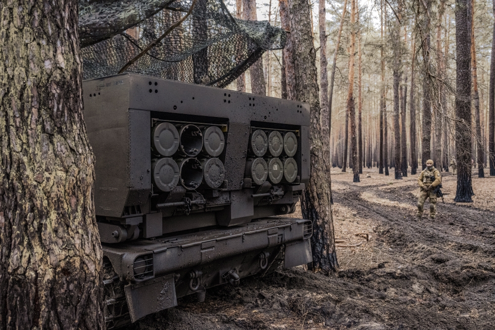 A Ukrainian soldier with a mobile rocket launcher in eastern Ukraine on March 9, 2023. (Daniel Berehulak/The New York Times)