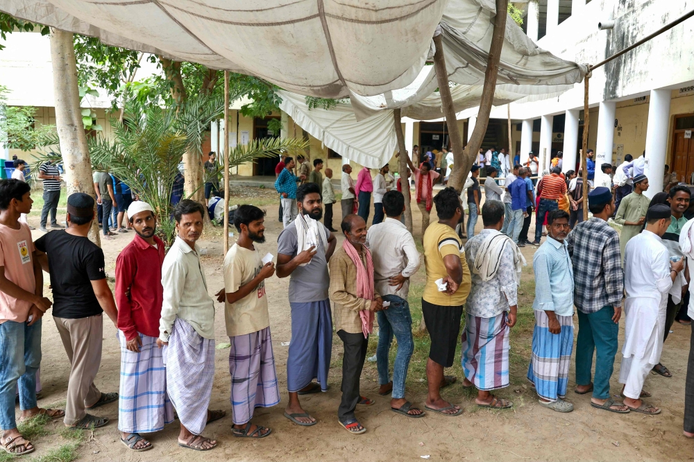 Voters queue up to cast their ballots at a polling station in Varanasi, India . — AFP 