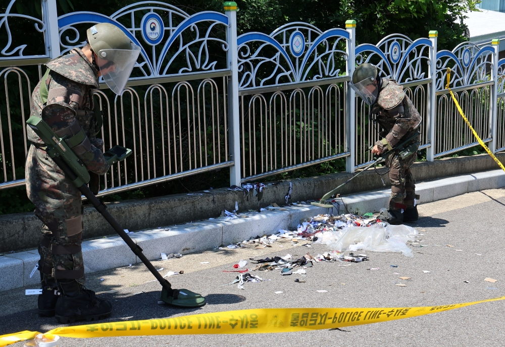 S Korean soldiers examine various objects including what appeared to be trash from a balloon believed to have been sent by N Korea, in Incheon, South Korea. — Reuters 