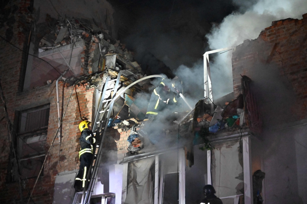 Rescuers extinguish a fire in an apartment building destroyed by a Russian missile attack in Kharkiv. — AFP file photo. 