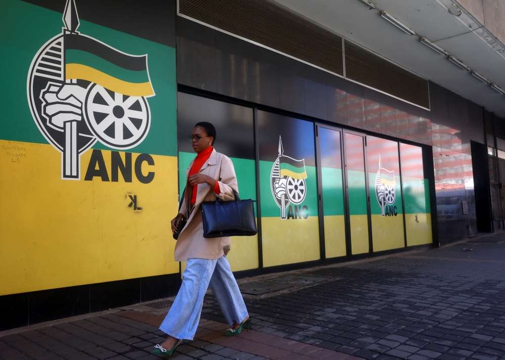 A woman walks past a logo of The African National Congress, at Luthuli House, in Johannesburg. — Reuters 